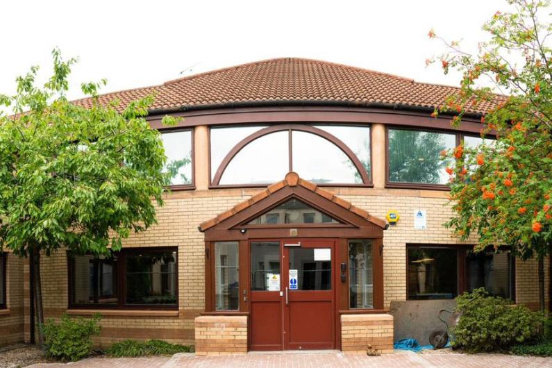 Front of phoenix future hose - a large building with a brown roof, window frames and front door