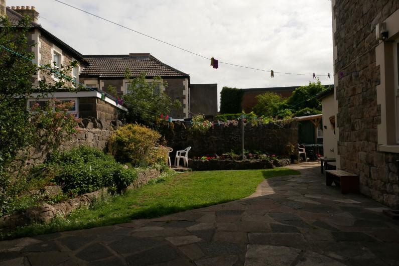 Western Counselling - outside. A patch of grass and a patio area surrounded by buildings