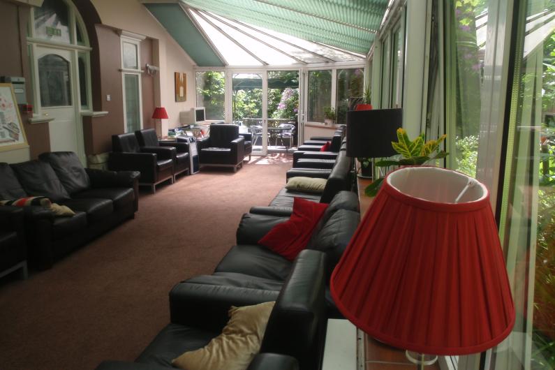 A long conservatory with a number of sofas facing in to each other