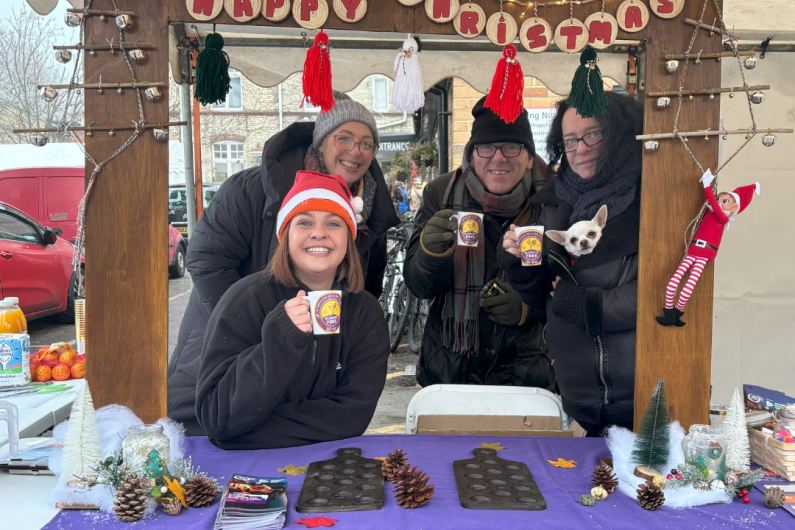 A group of people stood behind a stall