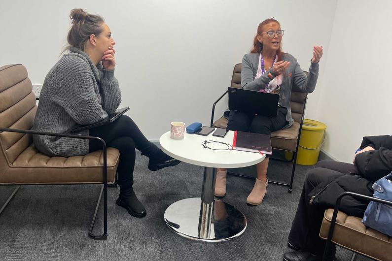 Two women sat talking