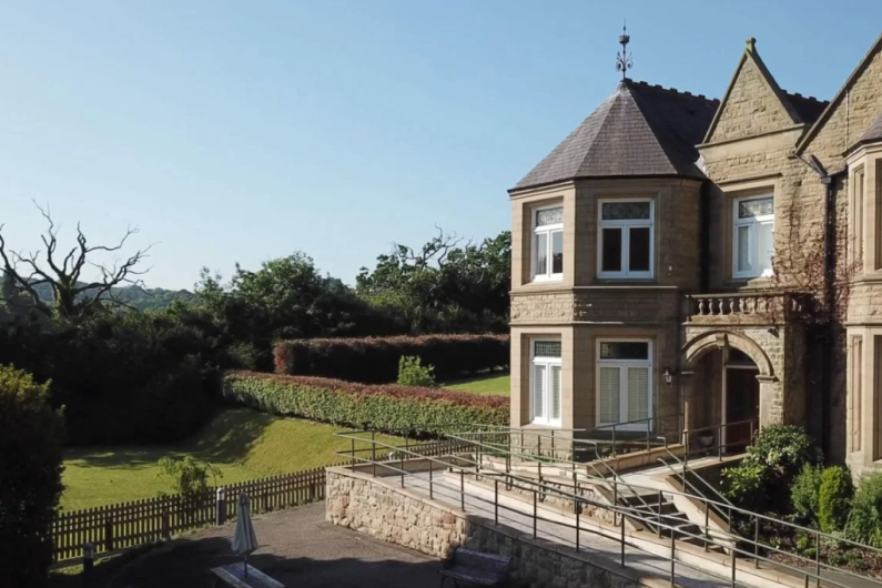 An old Victorian mansion with a sprawling garden