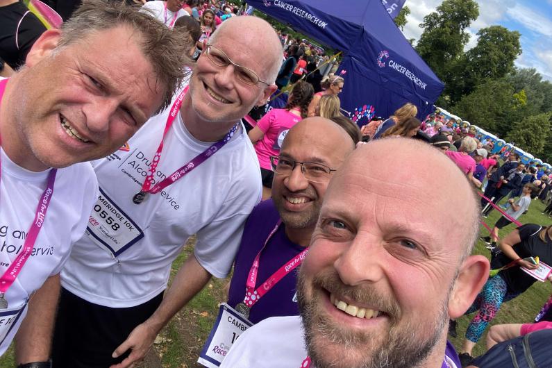 Three people taking a selfie with medals round their necks from Race for life