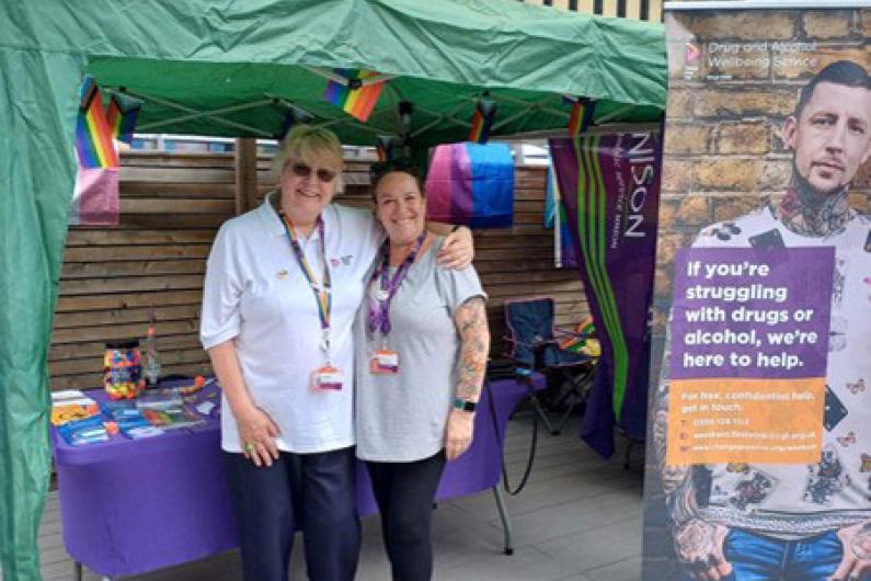 Two women stood under a gazebo