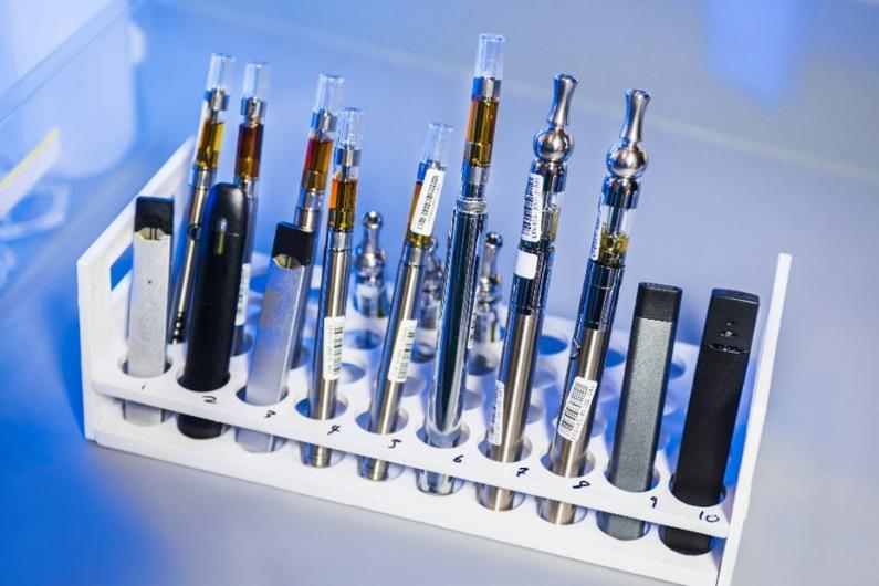 A number of vape pens placed inside a test tube rack