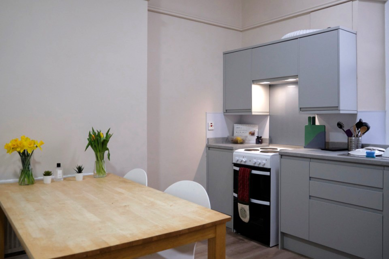 A small kitchen area with a dining table